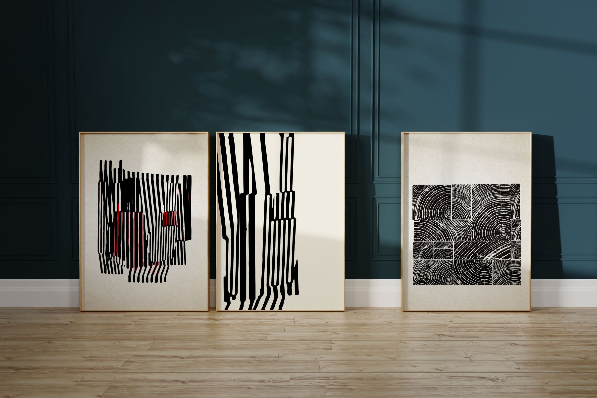 TripTych Black and white modern art pieces against a blue wall
